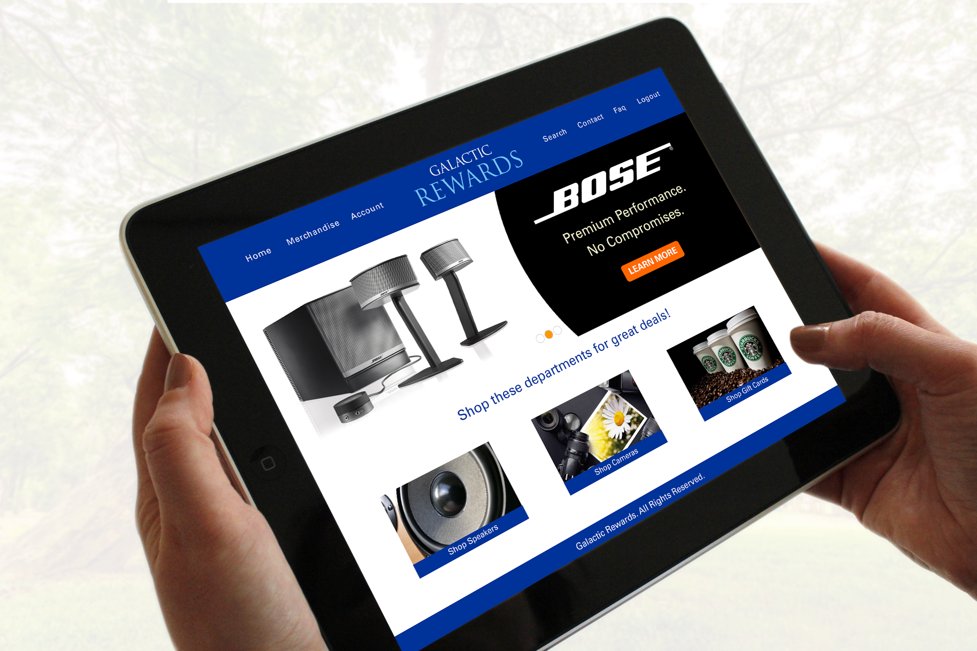 Hands holding a tablet displaying the Galactic Rewards homepage UI layout featuring Bose promotional banners and shop department cards. 